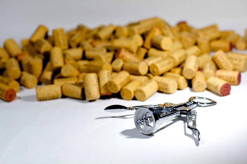 pile-of-corks-and-corkscrew